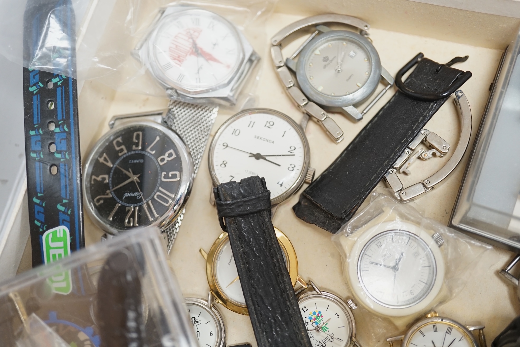 A group of assorted modern wrist watches including Sekonda, Camel and Timex Snoopy, together with two alarm clocks including Mickey Mouse. Condition - poor to fair